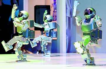 Three Sony humanoid robots dance